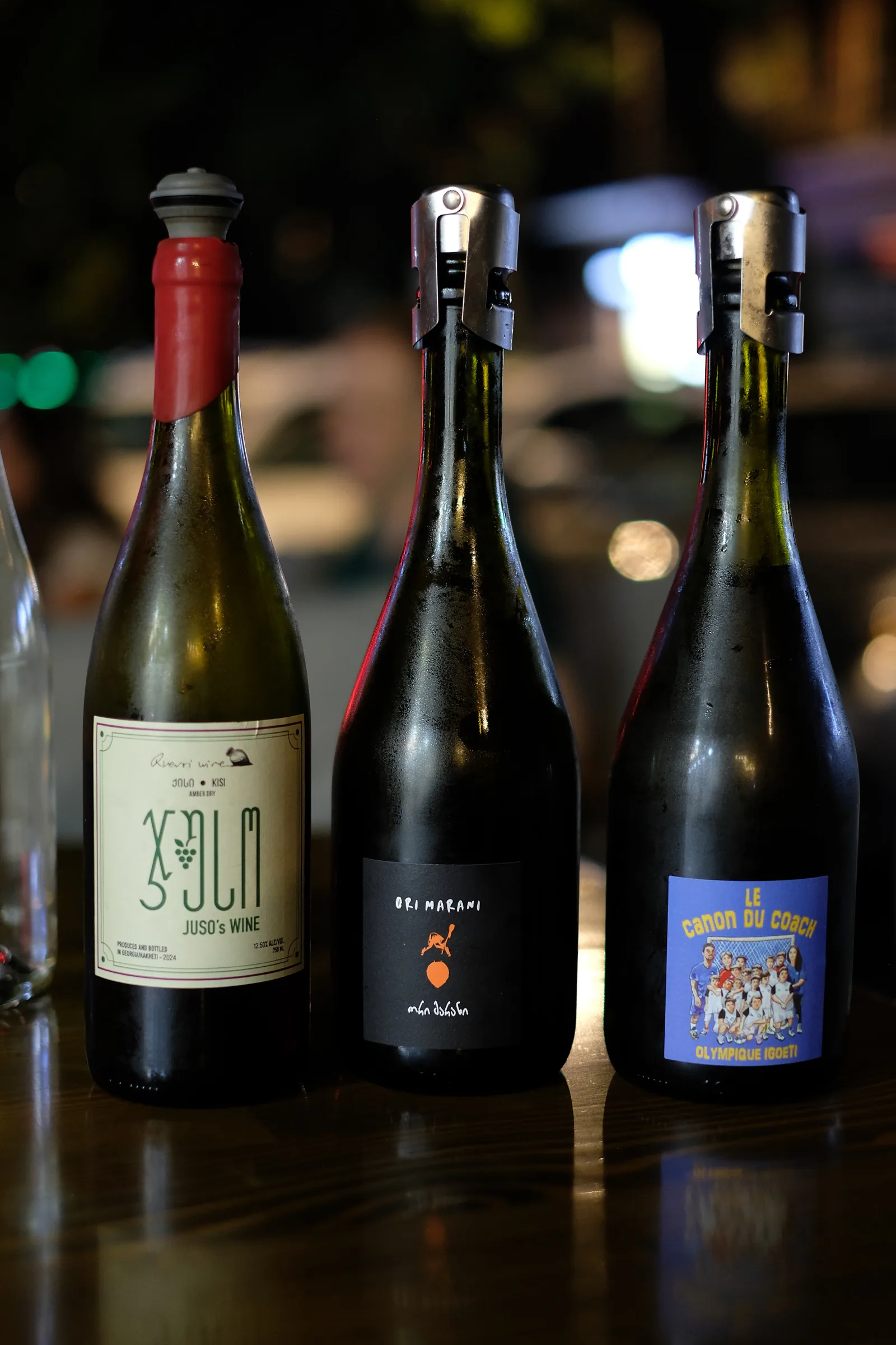 Three wine bottles on the table at MIDI, including Juso's Wine Kisi and an Ori Marani sparkling wine.