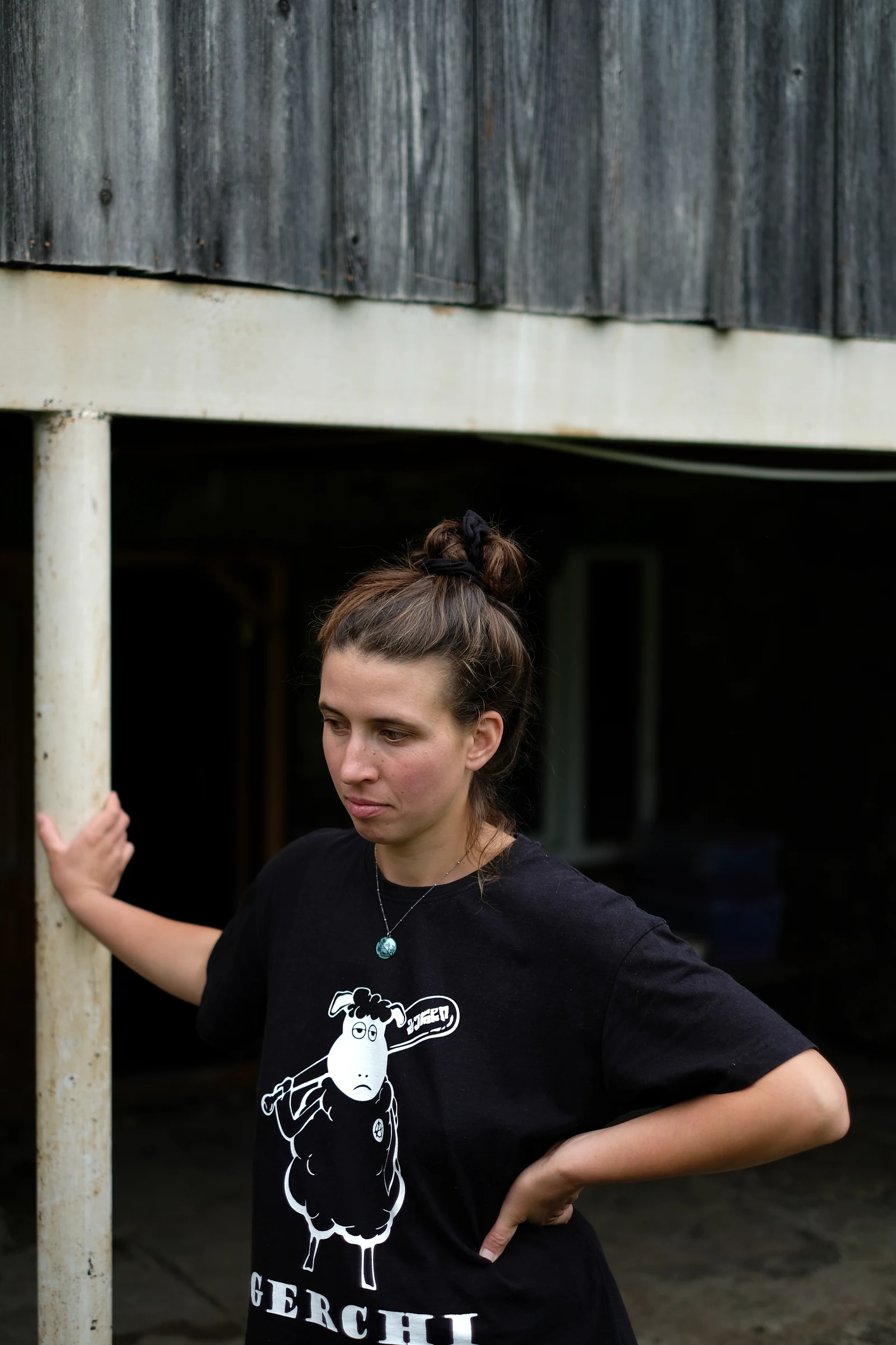 Ének Peterson standing outside her house in Persati.