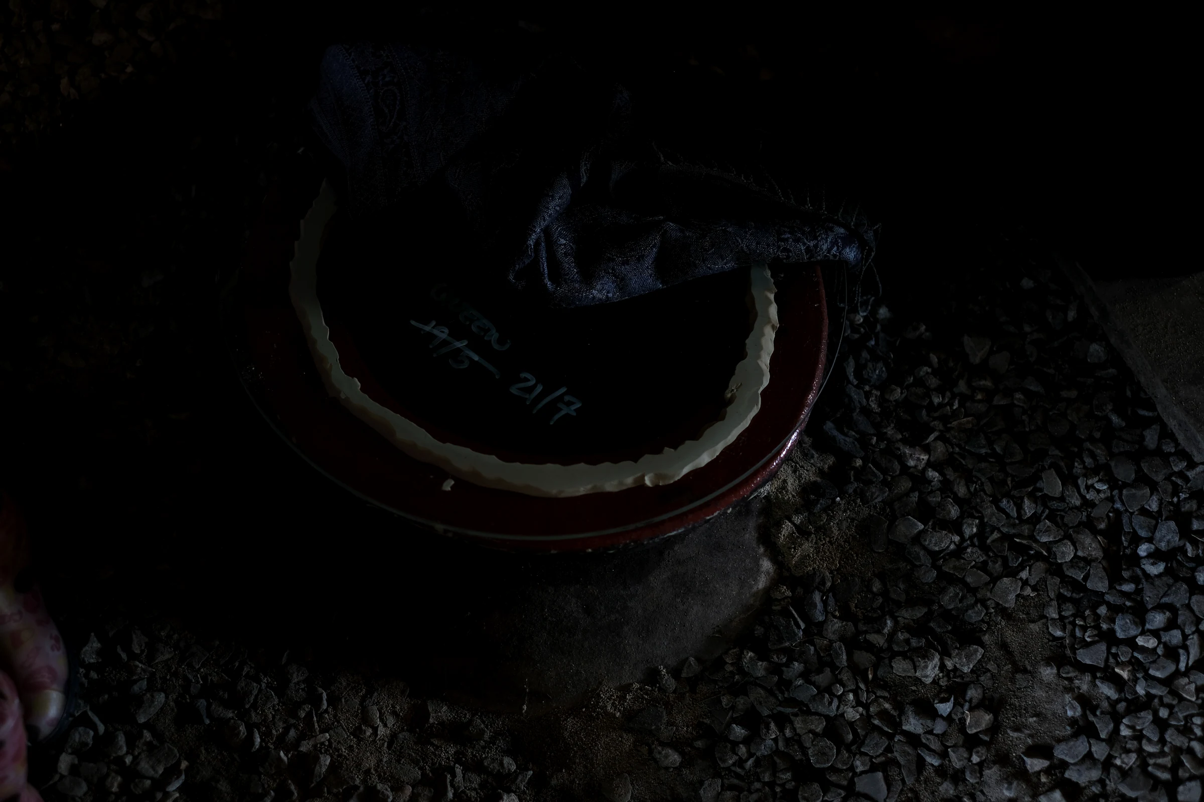 A covered above-ground qvevri set into the gravel floor of Ének Peterson's cellar.