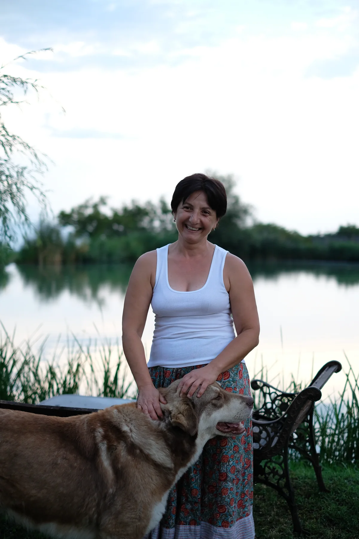 Eka smiling beside Gildi, with the lake behind them.