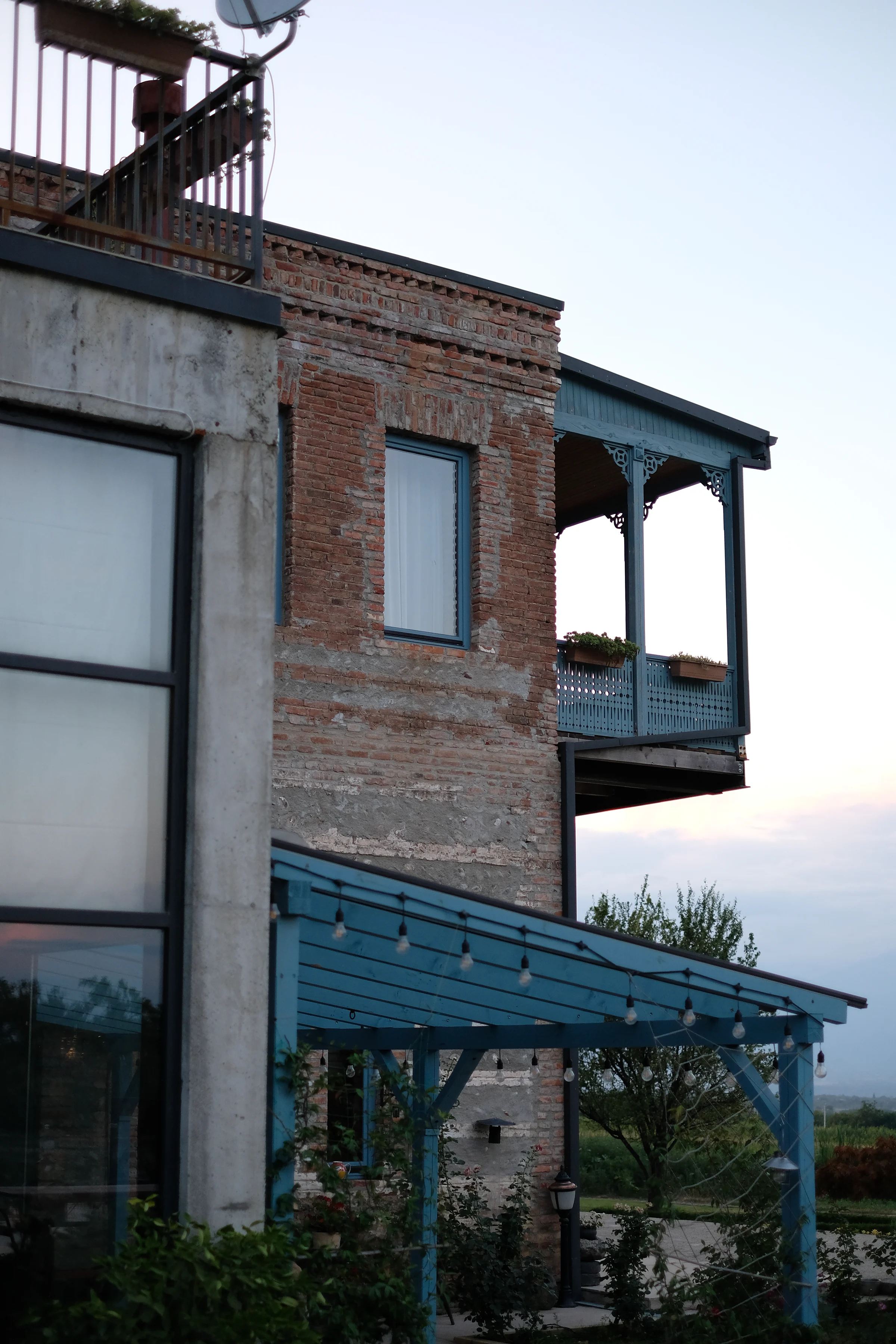 The brick house at Two&Half Qvevri, with its blue wooden verandah.